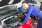 Mechanic repairing a car in a workshop or garage