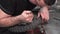 Mechanic repairing damaged motorcycle tire, in repair shop.