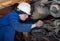 The mechanic repairs the big engine of the truck