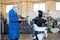 Mechanic repairs Promobot - service robot for business He communicates with people, answers questions, moves freely and