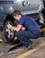 Mechanic Replacing Car Tire At Garage