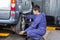 Mechanic Replacing Car Tire At Repair Shop