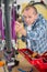 Mechanic serviceman adjusting bicycle gear on wheel in workshop