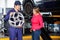 Mechanic Showing Hubcap To Customer