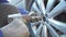 Mechanic tightening wheel nuts on a vehilce in auto service