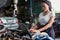 Mechanic using compute for Diagnostic  machine tools ready to be used with car. Car mechanic using a computer laptop to diagnosing