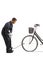 Mechanic using a manual pump for a flat front tire of a bicycle