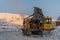 A mechanic walks past a drilling rig.