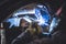 Mechanic welding on a car in an auto service repair shop.