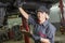 Mechanic woman working on car in his shop