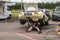 Mechanic working on classic car in the paddock area of a race track