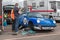 Mechanic working on classic porche car in the paddock area of a race track