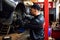 Mechanic works on a car in a car repair shop.