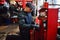 Mechanic works on a car in a car repair shop.