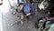 Mechanic works on a sidewalk in Thai capital