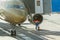 Mechanical engineer worker checks the engine fan of airplane before departure from airport.