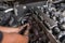 Mechanical guy using hand to remove some parts from the diesel engine box. Diesel engine during service, or maintenance at the