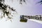 Mechanical ladder of firefighters seen from below with blue sky in the background