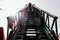 Mechanical ladder of firefighters seen from below with blue sky in the background