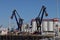 Mechanical lifting arms on a jetty at Crude oil storage terminal Vopak in the Welplaat harbor in the port of Rotterdam