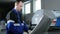 Mechanical technician programming punching the machine CNC. A man enters the data carefully to control panel. Metal is