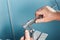 Mechanical technician worker hands measuring detail tool after processing at workshop with sliding caliper