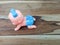 Mechanical wind up crawling baby toy on wood background.