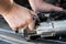 Mechanics with dirty hands repair broken starter on car/ Automotive service