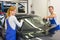 Mechanics or glaziers install windshield or windscreen on car