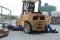 mechanics at work under the forklift