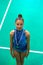 Medalist gymnastics teen girl holds medal
