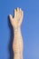 Medical acupuncture model of human hand on blue