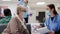 Medical assistant and elderly patient doing checkup consultation