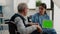 Medical assistant holding tablet with horizontal green screen