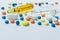 Medical background.Many multi-colored pills and ampoules for injections on a white background. Copy space.