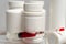 medical background. pill bottles without labels, syringe with red liquid