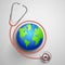 Medical background showing World Health Day with stethoscope around Earth
