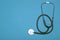 Medical background. Stethoscope on a clear blue background. Pharmacology, clinic, health and disease treatment concept