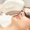 Medical beauty laser cosmeology procedure. Young female at salon. Professional doctor. Woman skincare technology. Hair removal