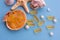 Medical capsules of omega 3 natural fish oil on a half of seashell on blue background