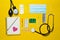 Medical cardiological equipment on a yellow background. Blisters pills, notebook, stethoscope, syringe, thermometer, manometer.