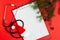 Medical Christmas concept with stethoscope, blank clipboard with white paper
