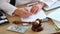 Medical clinic lawyer works with health insurance and financial documents at his desk.