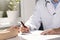 Medical consultation - doctor and patient sitting by the table