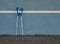 Medical crutch at blue training tennis wall on outdoor stadium players court,