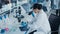 Medical Development Laboratory: Caucasian Female Scientist Looking Under Microscope, Analyzing Pet