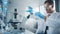Medical Development Laboratory: Male Scientist Mixes Liquid Chemicals In Glassware Beakers, Conduc