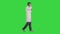 Medical doctor calling by phone walking on a Green Screen, Chroma Key.