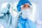 Medical doctor or laborant in hazmat protective suit holding tube with nCoV Coronavirus vaccine for 2019-nCoV virus