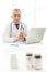 Medical doctor.Mature doctor sitting at his working place with